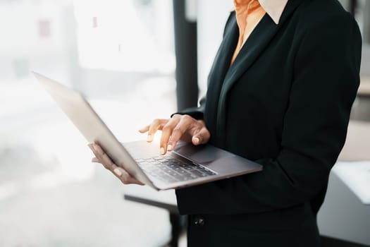 Beautiful young teen American African holding computer laptop with planning working on financial document, tax, exchange, accounting and Financial advisor.