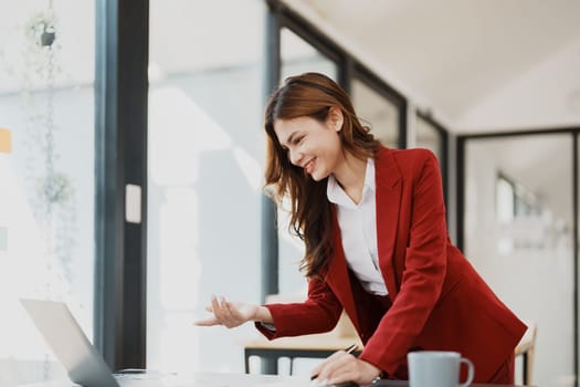 Beautiful young teen asian business woman meeting at on computer laptop with planning working on financial document, tax, exchange, accounting and Financial advisor.