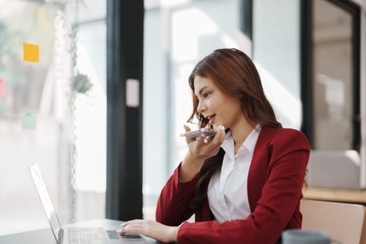 Beautiful young teen asian businesswoman using computer and smartphone mobile with planning working on financial document, tax, exchange, accounting and Financial advisor.