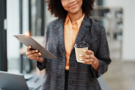 Beautiful young teen American African working on digital tablet with in do document, tax, exchange, accounting and Financial advisor.