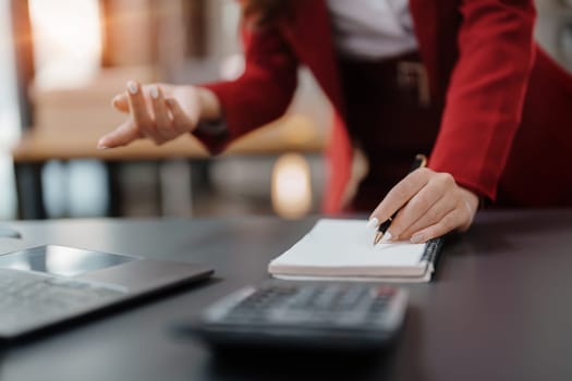 Beautiful young teen asian business woman meeting at on computer laptop with planning working on financial document, tax, exchange, accounting and Financial advisor.