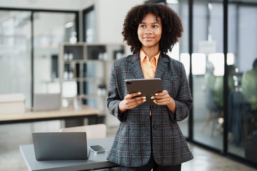 Beautiful young teen American African working on digital tablet with in do document, tax, exchange, accounting and Financial advisor.