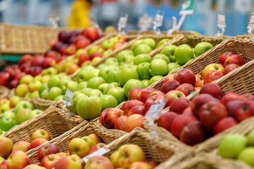 Apples on the shelves of a grocery store. Sale of fresh fruit. Selective focus