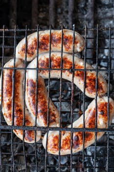 Grilled sausages with sauce and vegetables. Summer rest concept