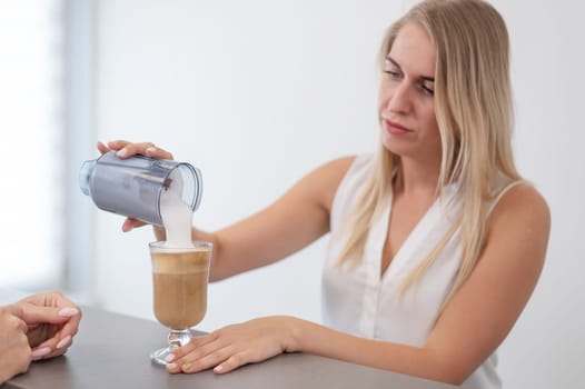 Receptionist in a beauty salon prepares coffee for a client