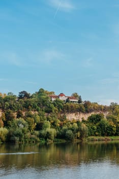 Autumn Landscape - River And Shores With Trees, Bushes And City Houses Marbach Am Neckar. Panoramic Aerial View Of The River In A City Park. Deciduous Trees, Golden Leaves. Autumn Landscape. Ecology, Pollution And Environmental Conservation, Fresh Air Themes. Marbach Am Neckar Is A Town About 20 Kilometres North Of Stuttgart. It Belongs To The District Of Ludwigsburg, The Stuttgart Region And The European Metropolitan Region Of Stuttgart.