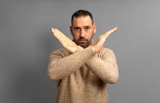 Close up photo amazing him he her middle age male hands palms arms crossed angry straight look won't pass through facial expression isolated on gray background.