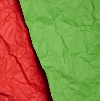 Crumpled red and green paper sheets, paper texture. Background for designers