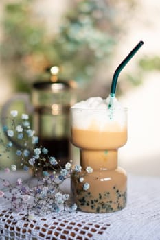 exotic latte with blue tapioca still life with beautiful flowers in the morning sun. High quality photo