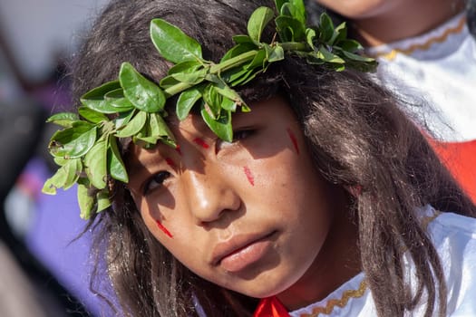 closeup of sad nazarene boy with blood on his face and a crown of leaves on his head. High quality photo