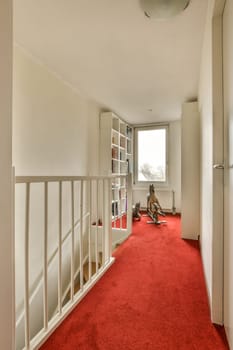 an empty room with red carpet and bookshels on the wall, in front of a white bookcase