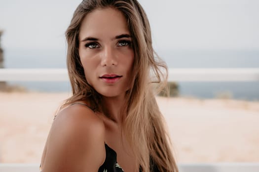 Happy woman portrait in cafe. Boho chic fashion style. Outdoor photo of young happy woman with long hair, sunny weather outdoors sitting in modern cafe