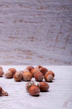 Hazelnuts on white wooden background in studio photo. Healhty snacks