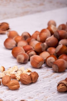 Nuts on white wooden background in studio photo. Healthy raw food