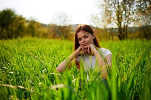 Beautiful healthy Young Woman relaxing on the green grass. High quality photo