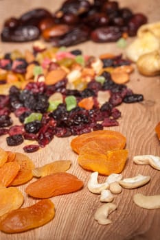 Mix of dried fruits on wooden background in studio photo. Healthy lifestyle