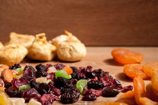 Mix of dried fruits on wooden background in studio photo. Healthy lifestyle