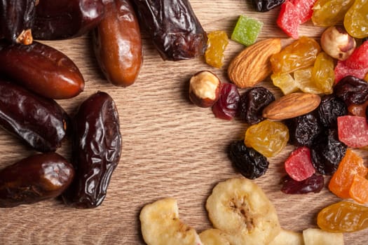 Mix of dried fruits on wooden background in studio photo. Healthy lifestyle
