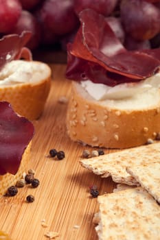 Pepper, sliced ham and cracker on wooden background close up shooting. Healthy lifestyle