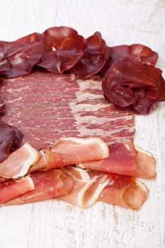 Delicious italian ham on wooden background. Restaurant appetizer