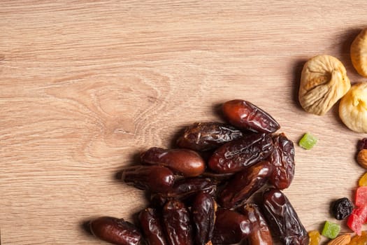 Mix of dried fruits on wooden background in studio photo. Healthy lifestyle