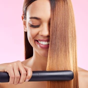Happy, woman and hair straightener for beauty, salon treatment and girl on studio background. Female, lady and tool for cosmetics, texture and volume with grooming, shine and glow with smile and spa.