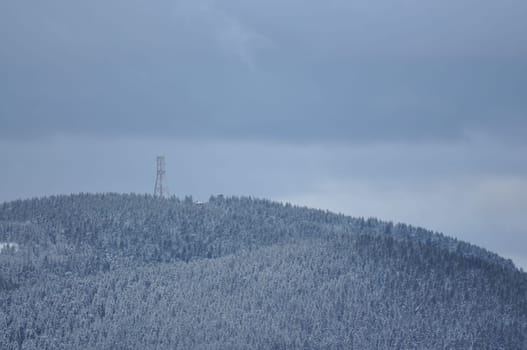 Aerial view of a steel tower on the snowy Brocken in the Harz mountains in Germany