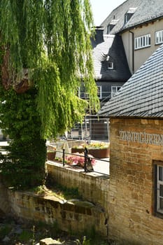 Old mill next to a weeping willow in the historic old town of Goslar in Germany