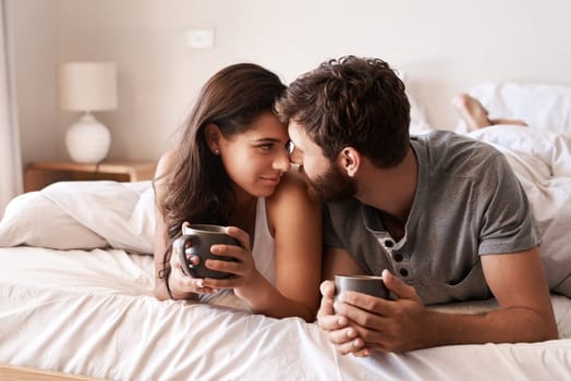Putting romance into routine. a happy young couple having coffee together in bed at home
