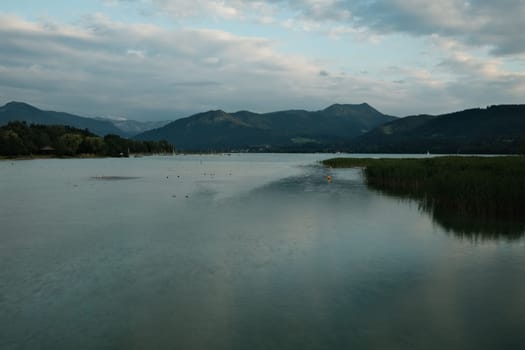 Gorgeous view of the Tegernsee in Bavaria, Germany with tall green hills reflected in the water