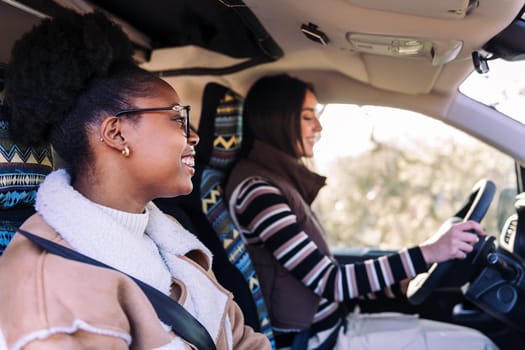 two young women in vacation with best friend in a camper van, concept of adventure and active tourism