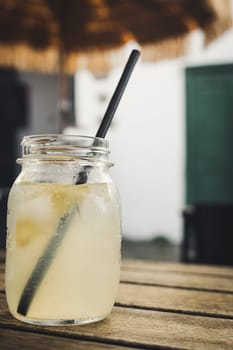 Vertical shot of a jar with homemade lemon lemonade .
