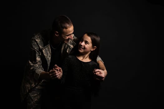 military man and daughter on a black background