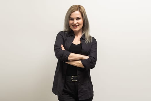 Image of happy young business woman posing isolated over grey wall background