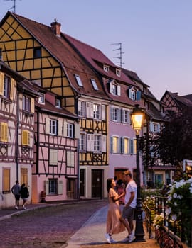 Couple of men and women on a city trip at Colmar France Beautiful view of the colorful romantic city of Colmar in the evening, the Historic town of Colmar, Alsace region, France