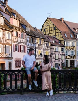 Couple of men and women on a city trip at Colmar France Beautiful view of the colorful romantic city of Colmar in the evening, the Historic town of Colmar, Alsace region, France