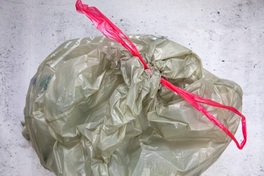green plastic garbage bag for plastic waste, ready to recycle, waste management top view eco