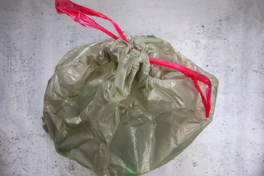 green plastic garbage bag for plastic waste, ready to recycle, waste management top view eco