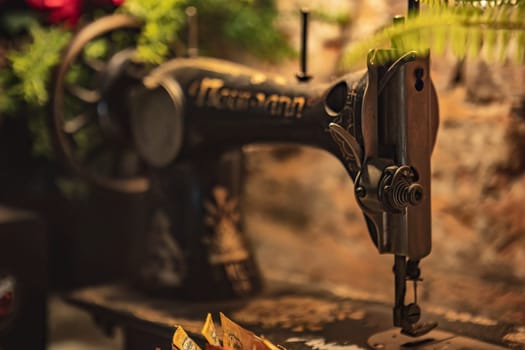 A vintage sewing machine, a testament to the Industrial Revolution, displaying intricate details and mechanical design