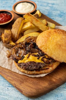 Hamburger with caramelized onions, with sauces and french fries