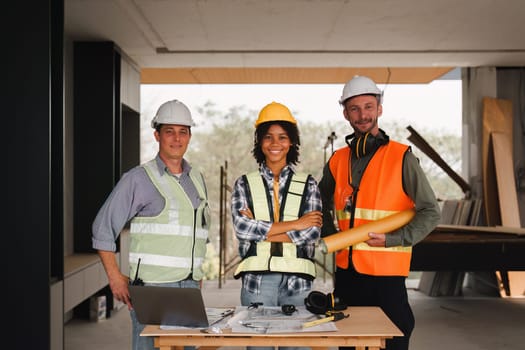 Engineer and Foreman builder team at construction site. American African foreman construction standing at construction site.