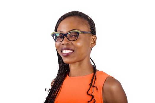girl standing in glasses on white background looking at camera smiling.