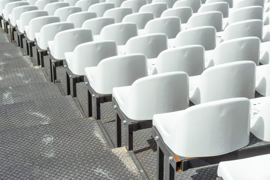 Seats of tribune on sport stadium. Concept of fans, chairs for audience, cultural environment concept. mpty seats, modern stadium