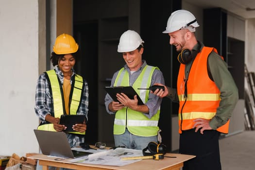 Engineer and Foreman builder team at construction site. American African foreman construction standing at construction site.