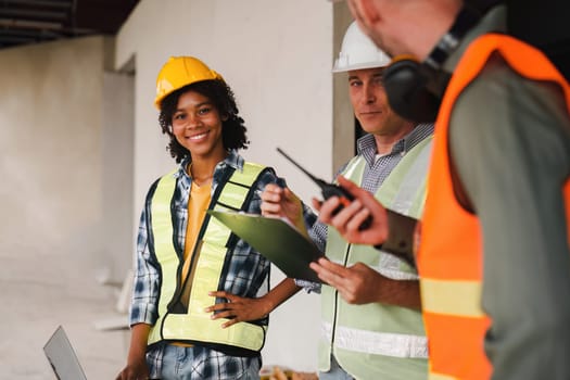 Engineer and Foreman builder team at construction site. American African foreman construction standing at construction site.