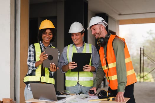 Engineer and Foreman builder team at construction site. American African foreman construction standing at construction site.