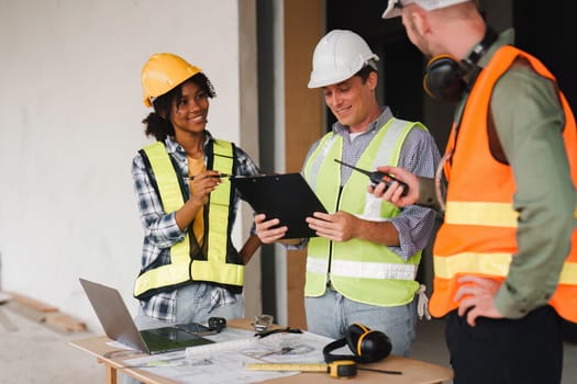 Engineer and Foreman builder team at construction site. American African foreman construction standing at construction site.