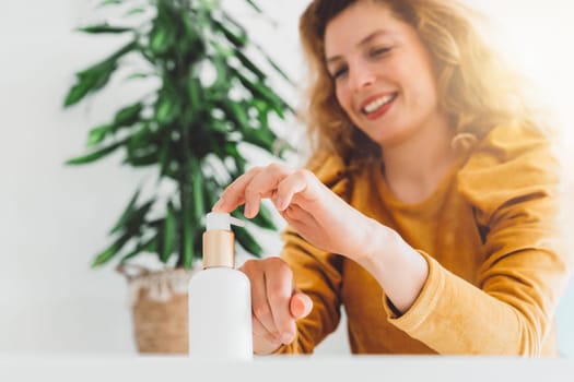 Self-Care Concept. Portrait Of Attractive Adult Female doing skin and hair care at home. Beauty at home. Woman doing make up, brushing her hair. High quality photo