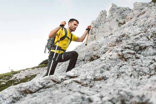 Caucasian man Hiking with Backpack on the Beautiful trail in European Alps early in the morning. Travel and Adventure Concept. High quality photo