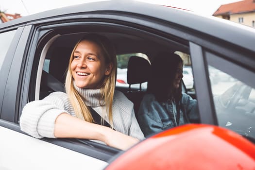 Two young caucasian women having fun on city street outdoors - Best friends enjoying a holiday day out together - Happy lifestyle, youth and young females concept. High quality photo